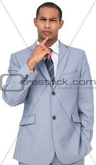 Thinking young businessman in blue suit