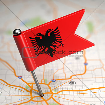 Albania Small Flag on a Map Background.