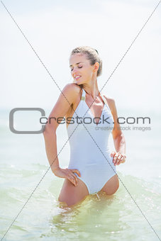 Young woman in swimsuit standing in sea