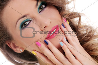 Beautiful girl touch her face with colored fingers