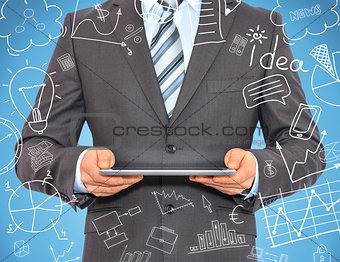 Man with tablet in hands and business sketches