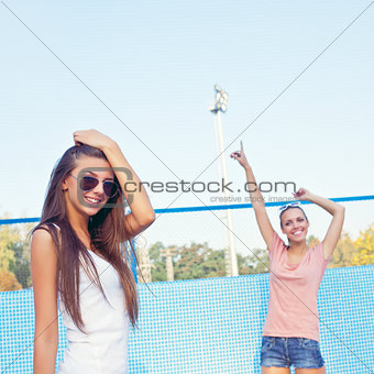 two beautiful young girls on the floor of an empty pool