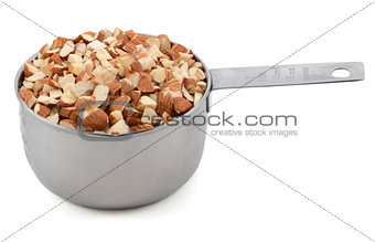 Chopped almonds in a metal cup measure