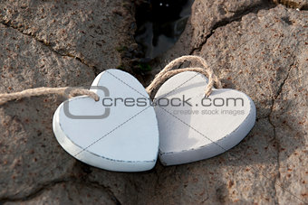 wooden love hearts on the sand bank