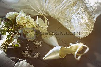 Wedding shoes with bouquet of  roses  on chair