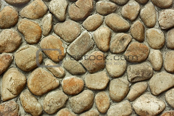 Old wall with rounded large boulders