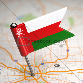 Oman - Small Flag on a Map Background.