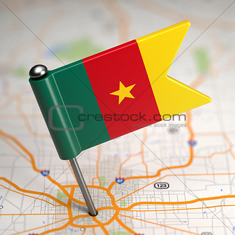 Cameroon Small Flag on a Map Background.