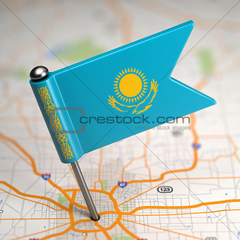 Kazakhstan Small Flag on a Map Background.
