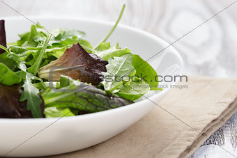 mesclun mix salad in white bowl