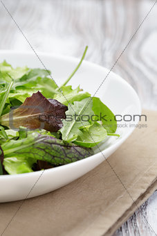 mesclun mix salad in white bowl