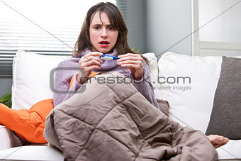 girl with a bad temperature on a sofa