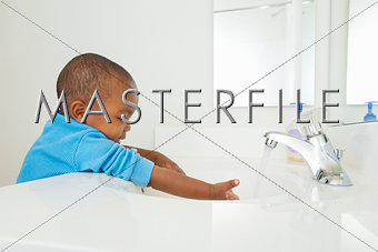 Toddler washing his hands