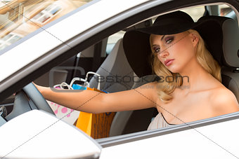 blond elegant girl in car looking