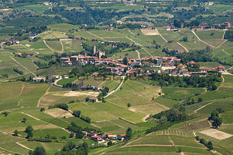Green hills and vineyards of Langhe in early spring in Piedmont, Northern Italy (view from above).