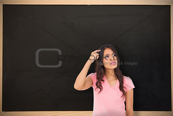 Composite image of pretty brunette thinking