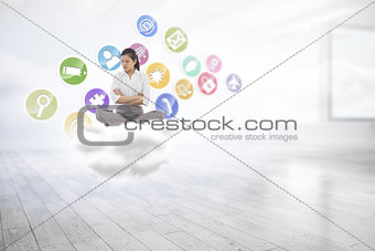 Composite image of grumpy businesswoman sitting cross legged