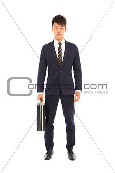 young businessman standing and holding a briefcase 