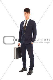 young businessman holding a briefcase and hand in his pocket