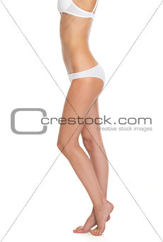 Closeup on legs of young woman in lingerie