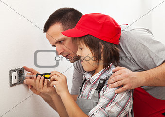 Father teaching son the basics of electrical work around the hou
