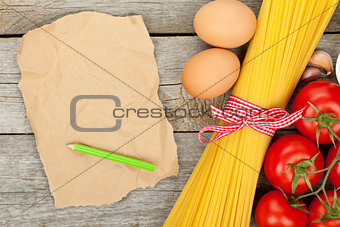 Pasta, tomatoes, eggs and blank brown paper