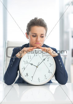 Frustrated business woman with clock