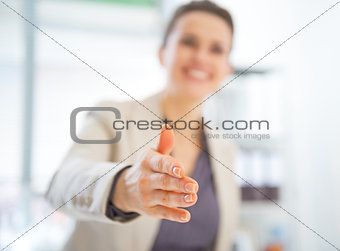Closeup on happy business woman stretching hand for handshake
