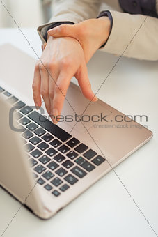 Closeup on business woman with wrist pain