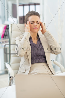 Portrait of business woman with head ache in office