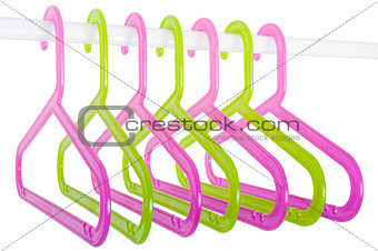 Colored hangers on a rod isolated on white