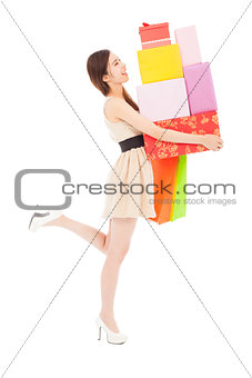 happy young woman holding gift box and shopping bag