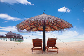 water villa with umbrella and beach chair .maldives