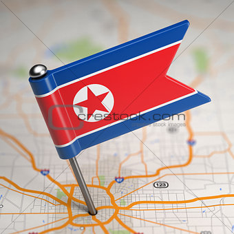 North Korea Small Flag on a Map Background.