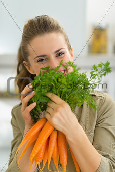 Young housewife holding carrot