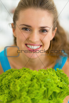 Portrait of happy young woman with fresh salad