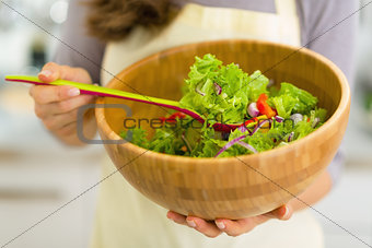 Closeup on young housewife with salad