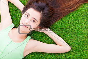 sunny pretty girl lying down on a meadow 