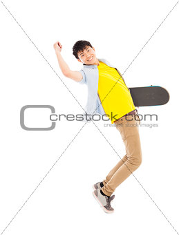 Vibrant young man holding a skateboard