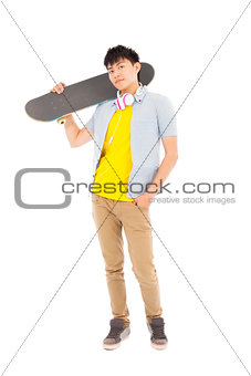young man standing and holding a skateboard 