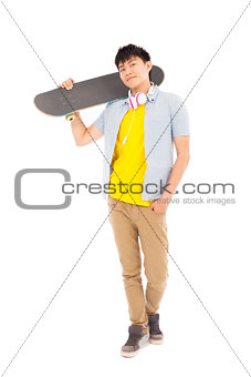 young man standing and holding a skateboard 