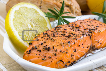 spicy smoked salmon with lemon and bread bun