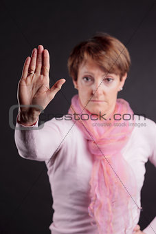 mature woman with a raised closed hand