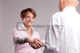 successful senior woman handshaking