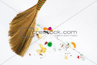 broom sweeping various debris