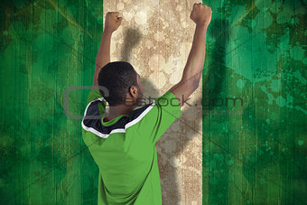 Cheering football fan in green jersey