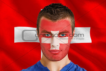 Serious young swiss fan with facepaint