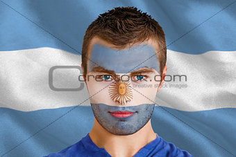 Serious young argentina fan with facepaint