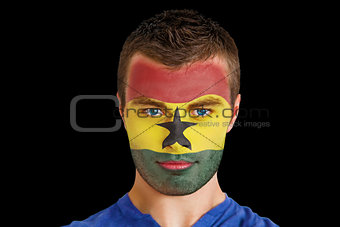 Serious young ghana fan with facepaint