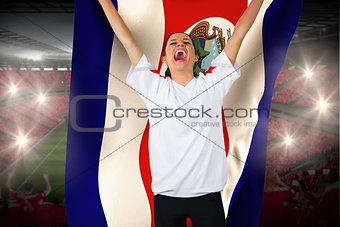 Football fan in white cheering holding costa rica flag
